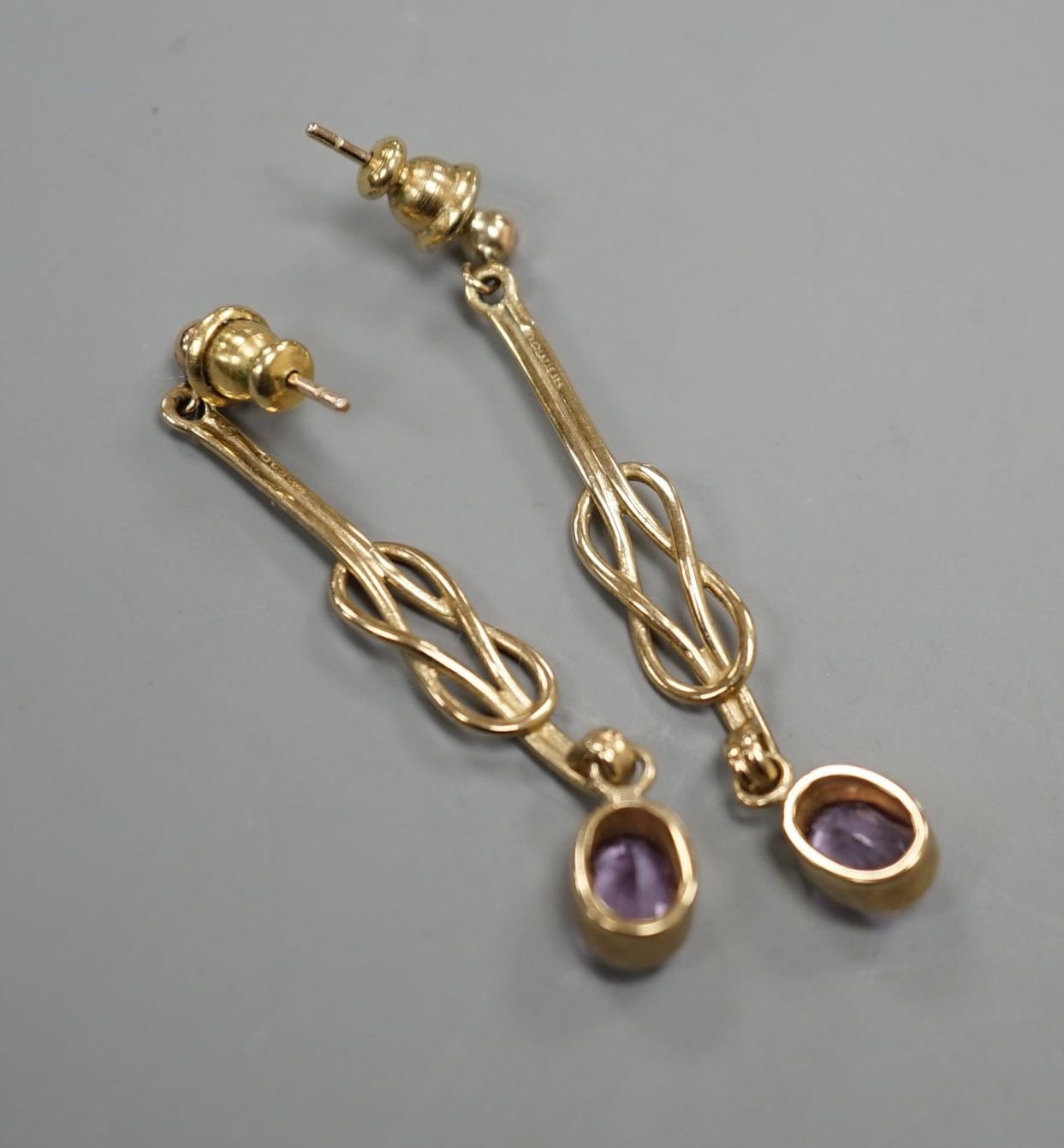 A modern pair of 9ct gold and amethyst set drop earrings, 4cm, gross 3.8 grams.